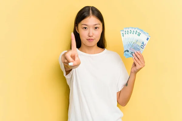 Young Asian Woman Holding Banknotes Isolated Yellow Background Showing Number — Stock Photo, Image