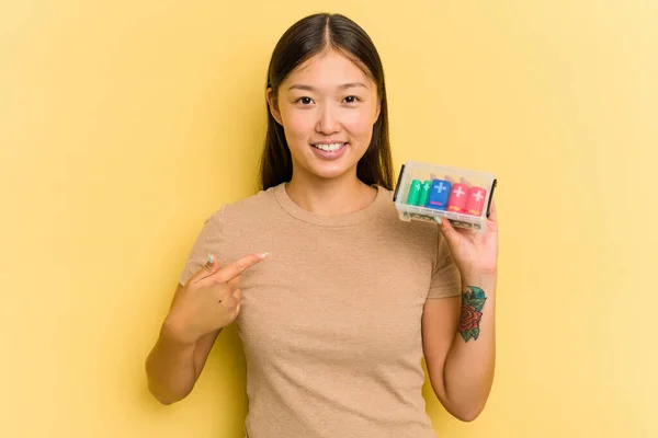 Young Asian Woman Holding Batteries Recycle Them Isolated Yellow Background — Stock Photo, Image