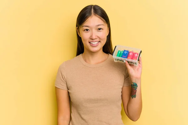 Young Asian Woman Holding Batteries Recycle Them Isolated Yellow Background — Stock Photo, Image