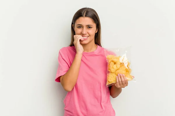 Young Indian Woman Holding Crips Isolated White Background Biting Fingernails — Stock Photo, Image