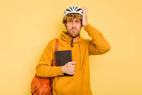 Młody Uczeń Noszący Rower Hełmie Odizolowany Żółtym Tle Jest Szoku — Zdjęcie stockowe