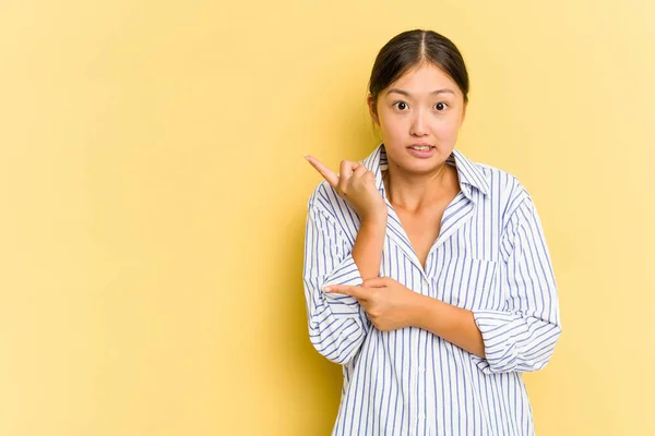 Jovem Asiática Isolada Fundo Amarelo Chocada Apontando Com Dedos Indicadores — Fotografia de Stock