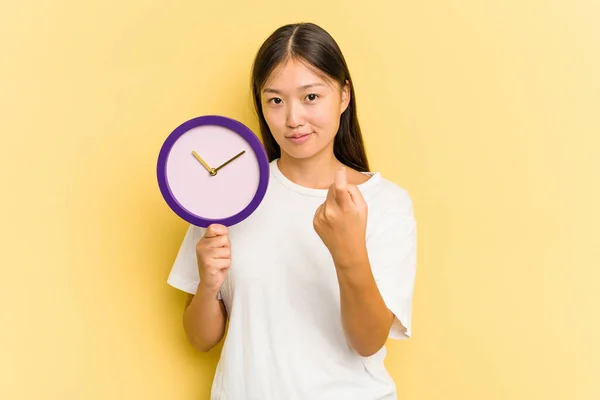 Giovane Donna Asiatica Possesso Orologio Isolato Sfondo Giallo Che Punta — Foto Stock