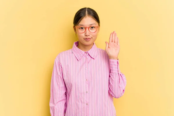 배경에 고립된 아시아 여자가 웃으며 손가락으로 번째를 줬습니다 — 스톡 사진