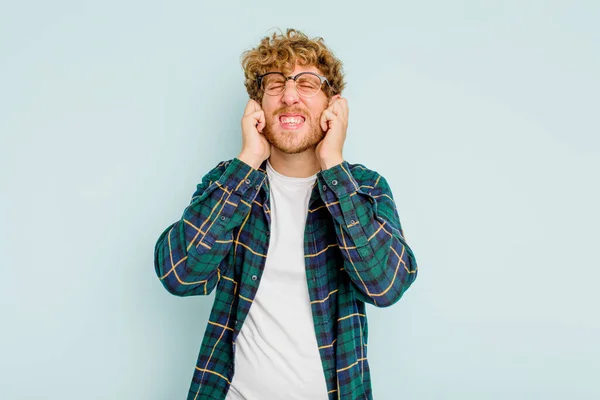 Jonge Blanke Man Geïsoleerd Blauwe Achtergrond Bedekt Oren Met Handen — Stockfoto