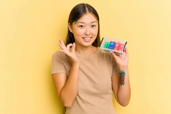 Młoda Azjatka Trzyma Baterie Recyklingu Odizolowane Żółtym Tle Wesoły Pewny — Zdjęcie stockowe