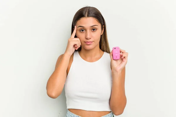 Young Indian Woman Holding Electronic Pink Car Keys Pointing Temple — Stock Photo, Image