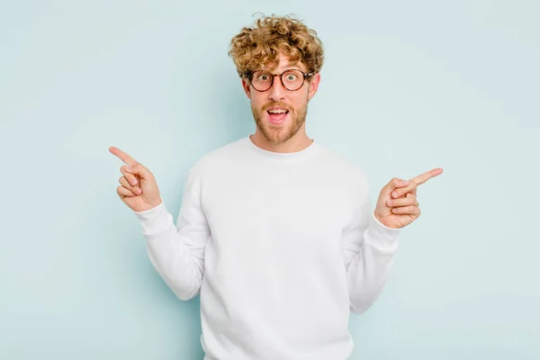 Young Caucasian Man Isolated Blue Background Pointing Different Copy Spaces — Stock Photo, Image