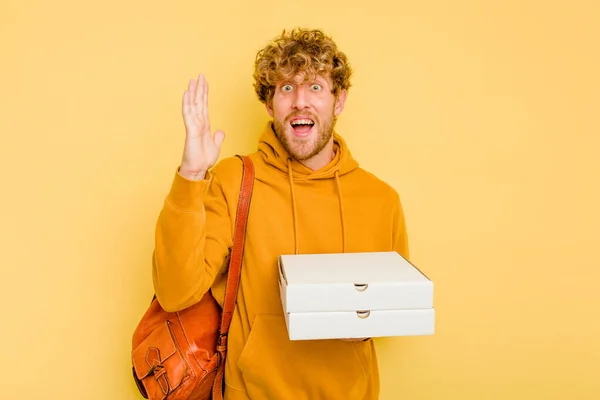 Young Student Man Holding Pizzas Isolated Yellow Background Receiving Pleasant — Stock Photo, Image