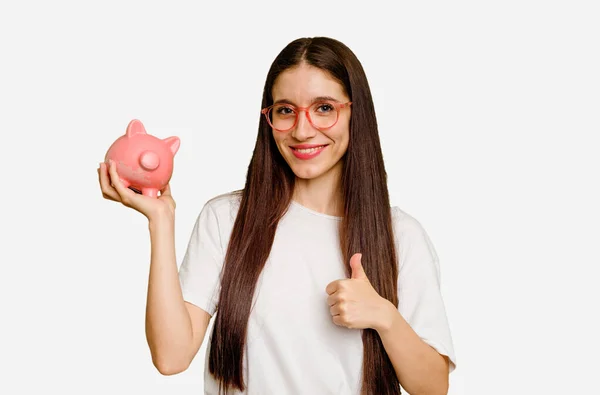 Young Caucasian Woman Holding Piggy Bank Isolated Smiling Raising Thumb — Stock Photo, Image