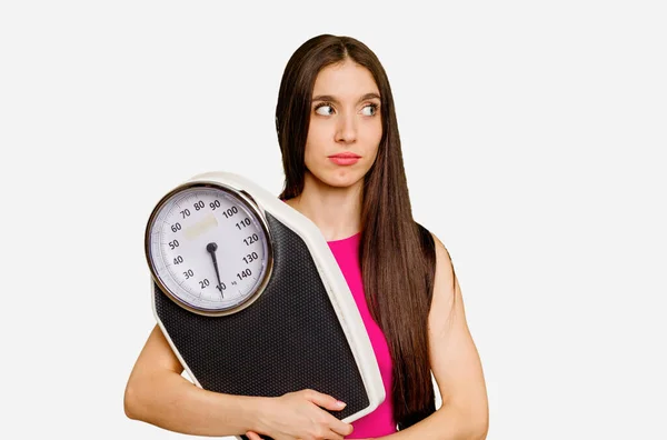 Young Caucasian Woman Holding Scale Isolated Confused Feels Doubtful Unsure — Stock Photo, Image