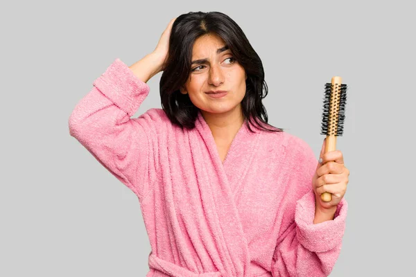 Young Indian Woman Bathrobe Holding Hairbrush Isolated Touching Back Head — Stock Photo, Image