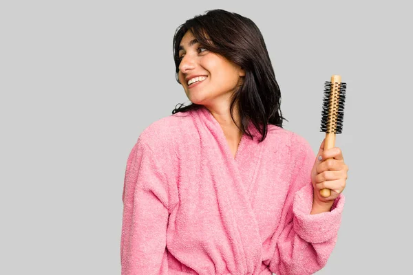 Young Indian Woman Bathrobe Holding Hairbrush Isolated Looks Aside Smiling — Stock Photo, Image