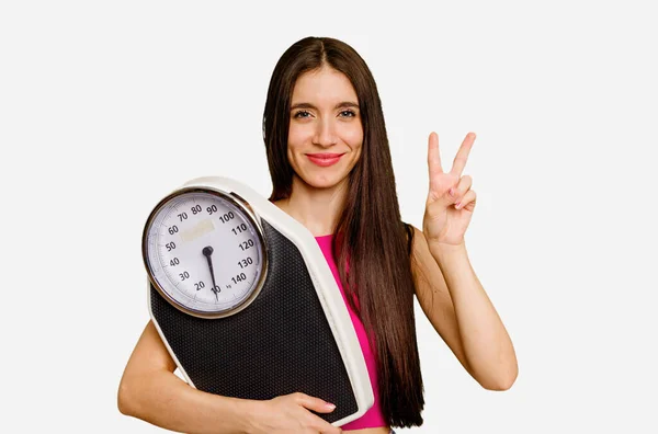 Young Caucasian Woman Holding Scale Isolated Showing Number Two Fingers — Stock Photo, Image