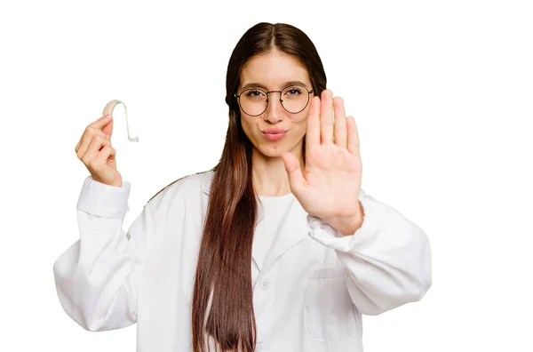 Young Otorhinolaryngologist Caucasian Woman Holding Hearing Aid Isolated Standing Outstretched — Stock Photo, Image