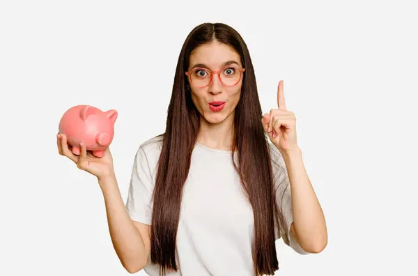 Young Caucasian Woman Holding Piggy Bank Isolated Having Some Great — Stock Photo, Image