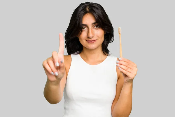 Young Indian Woman Holding Toothbrush Isolated Showing Number One Finger — Stock Photo, Image
