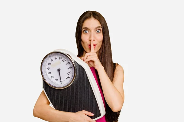 Young Caucasian Woman Holding Scale Isolated Keeping Secret Asking Silence — Stock Photo, Image
