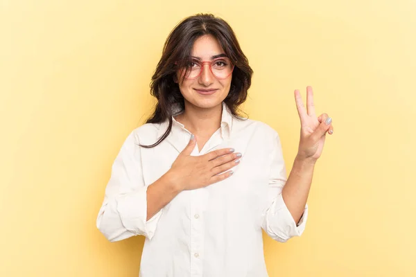 Young Indian Woman Isolated Yellow Background Taking Oath Putting Hand — Stock Photo, Image