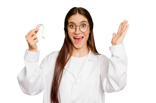Young Otorhinolaryngologist Caucasian Woman Holding Hearing Aid Isolated Receiving Pleasant — Stock Photo, Image