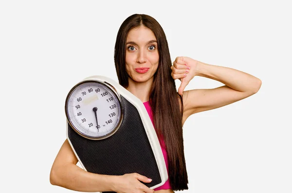 Young Caucasian Woman Holding Scale Isolated Showing Dislike Gesture Thumbs — Stock Photo, Image