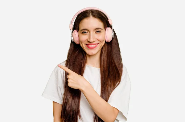 Mujer Caucásica Joven Con Auriculares Aislados Sonriendo Señalando Lado Mostrando —  Fotos de Stock