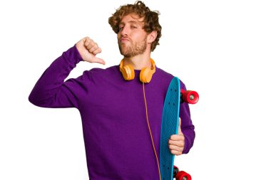 Young skater caucasian man isolated on white background feels proud and self confident, example to follow.
