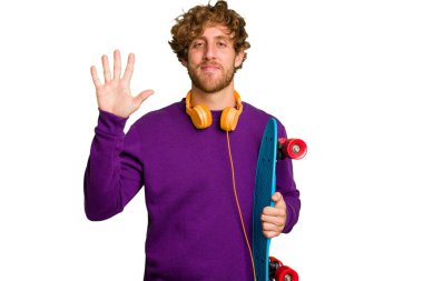 Young skater caucasian man isolated on white background smiling cheerful showing number five with fingers.