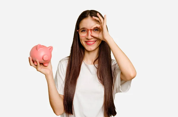 Young Caucasian Woman Holding Piggy Bank Isolated Excited Keeping Gesture — Stock Photo, Image