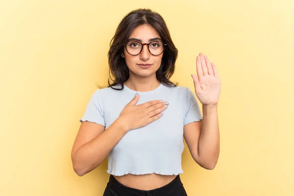 Young Indian Woman Isolated Yellow Background Taking Oath Putting Hand — Stock Photo, Image