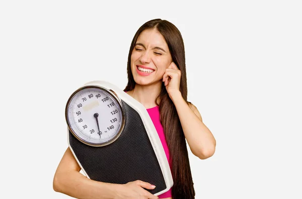 Young Caucasian Woman Holding Scale Isolated Covering Ears Hands — Stock Photo, Image