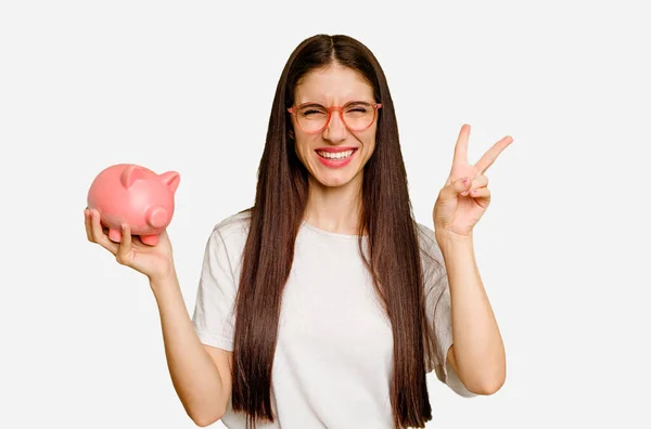 Young Caucasian Woman Holding Piggy Bank Isolated Joyful Carefree Showing — Stock Photo, Image