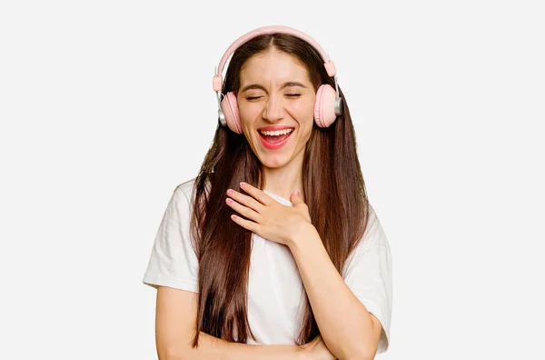 Joven Mujer Caucásica Con Auriculares Aislados Ríe Voz Alta Manteniendo —  Fotos de Stock