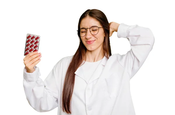 Young Pharmacist Woman Holding Tablet Pills Isolated Touching Back Head — Stock Photo, Image
