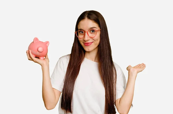 Young Caucasian Woman Holding Piggy Bank Isolated Showing Copy Space — Stock Photo, Image