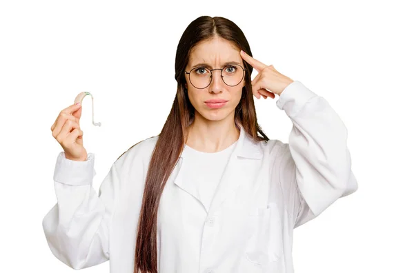 Young Otorhinolaryngologist Caucasian Woman Holding Hearing Aid Isolated Showing Disappointment — Stock Photo, Image