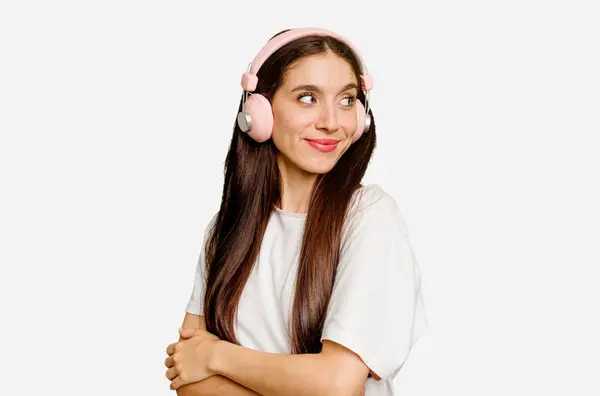 Young Caucasian Woman Wearing Headphones Isolated Looks Aside Smiling Cheerful — Stock Photo, Image