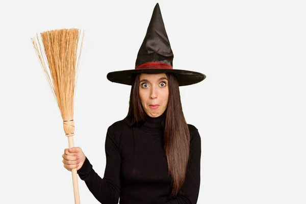 Young Caucasian Woman Dressed Witch Holding Broom Isolated Shrugs Shoulders — Stock Photo, Image