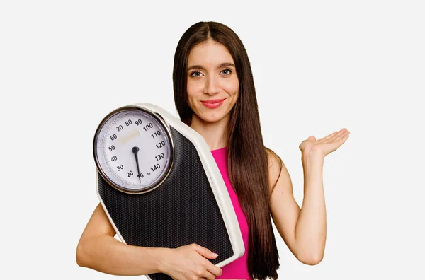 Young Caucasian Woman Holding Scale Isolated Showing Copy Space Palm — Stock Photo, Image