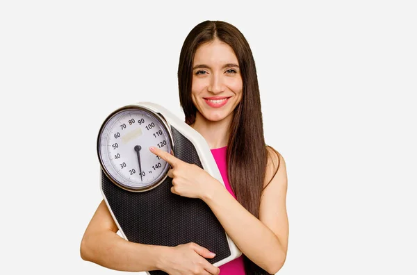 Young Caucasian Woman Holding Scale Isolated Smiling Pointing Aside Showing — Stock Photo, Image