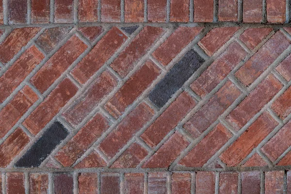 Photograph of a newly laid brick wall with a diagonal bond and a soldier course on the top and bottom