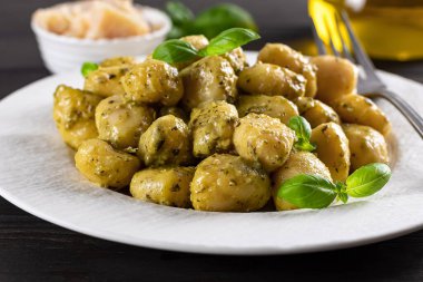 Gnocchi with pesto sauce and parmesan. Traditional Italian meal from potatoes. close up