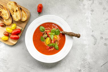 Tomato soup with fresh, crunchy vegetables and herbs. Served cold with hot bread. Spanish gazpacho recipe.