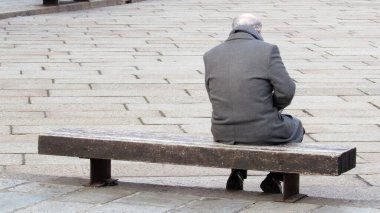 Lonely senior sitting on a bench - Depression and loneliness clipart