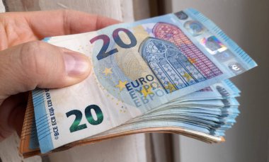Euro banknotes in the hands of a person