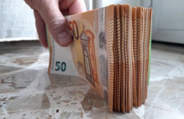 Euro banknotes in the hands of a person