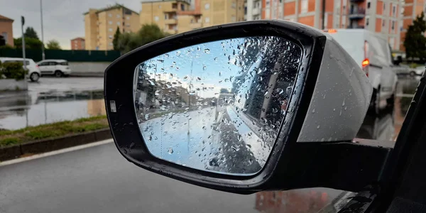 Car mirror while driving in the rain