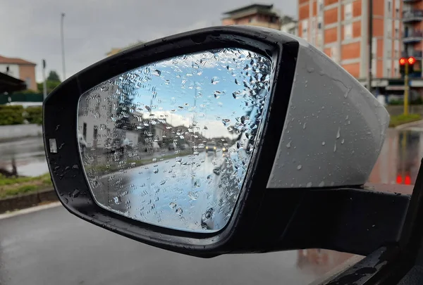 Car mirror while driving in the rain