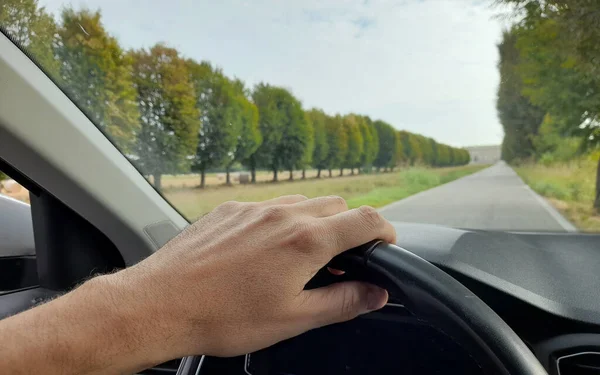 Drive your car on a country road in autumn