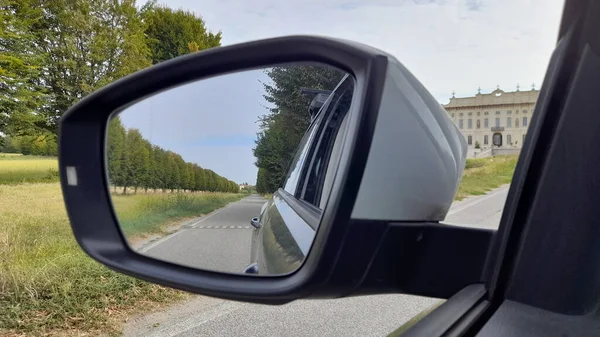 Car rear view mirror - driving in the countryside